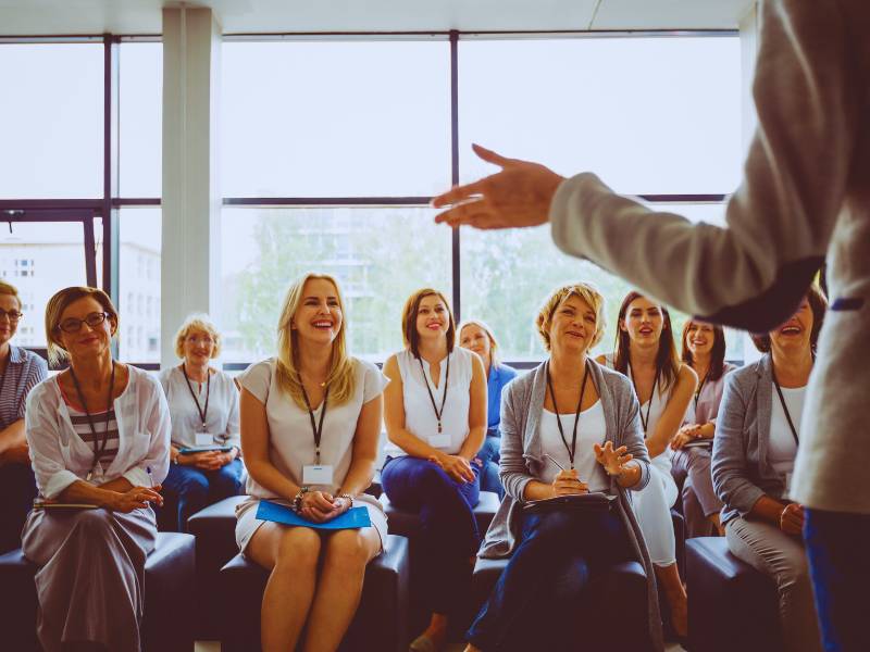 Employees participating in a corporate training session in a modern office setting.